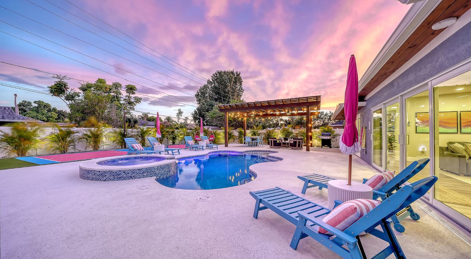 The Current's heated pool and backyard at sunset
