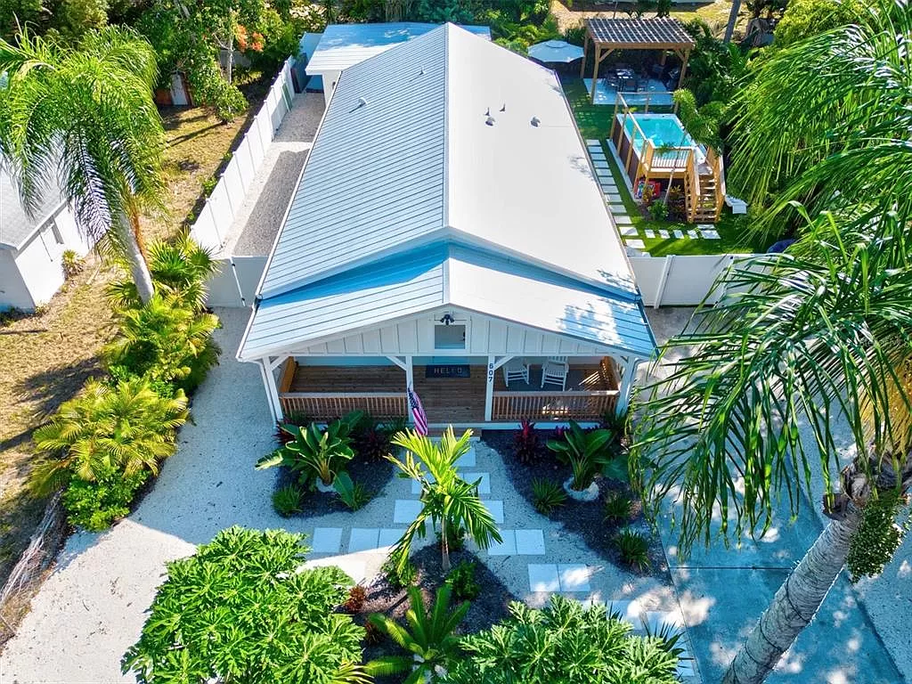 Aerial view of the backyard, pool, and pergola