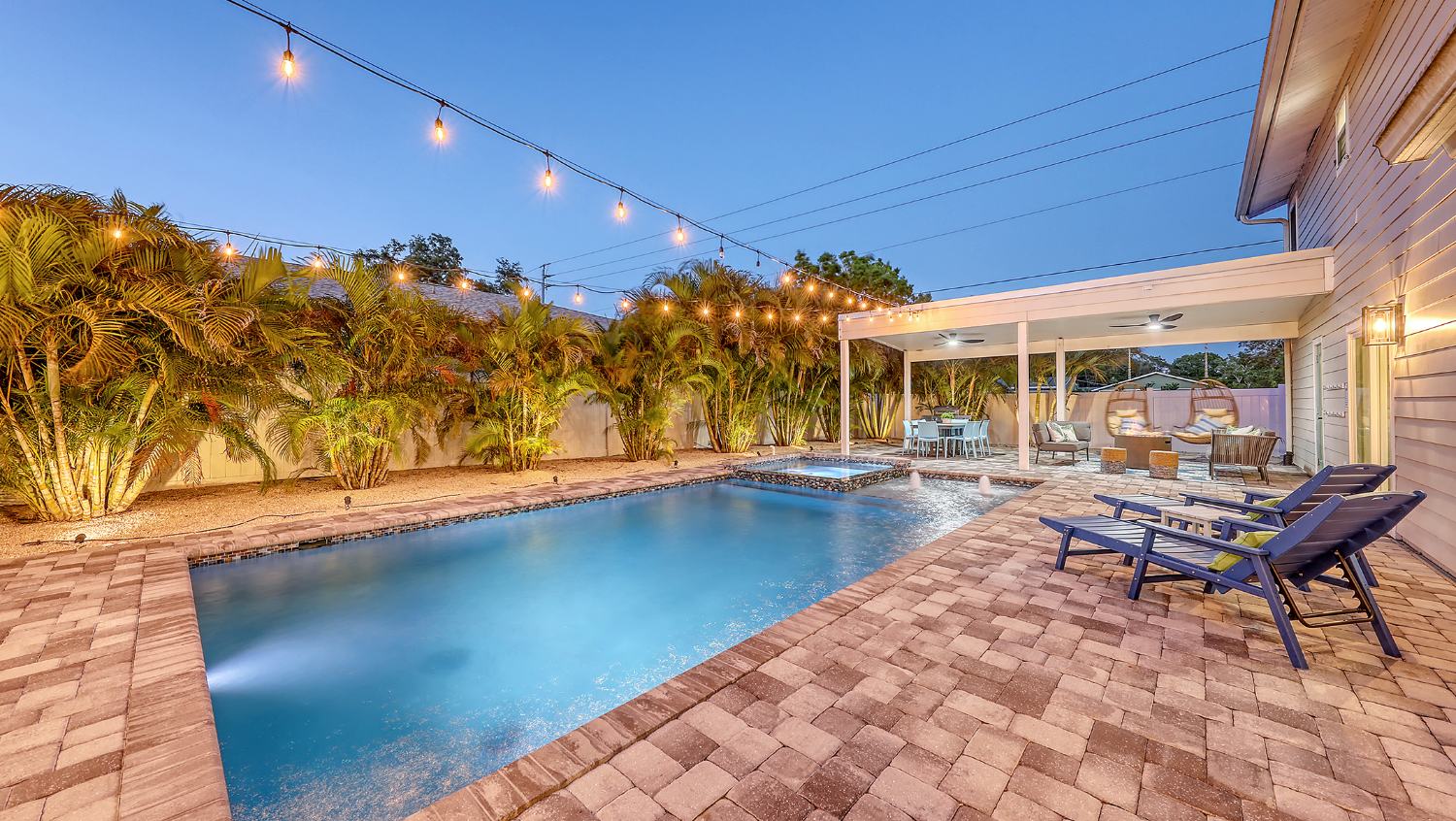 Leaf Me Here pool and lit guest house at twilight