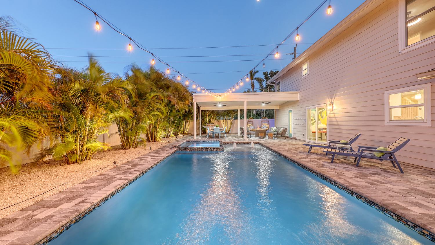 String lights over the pool at twilight